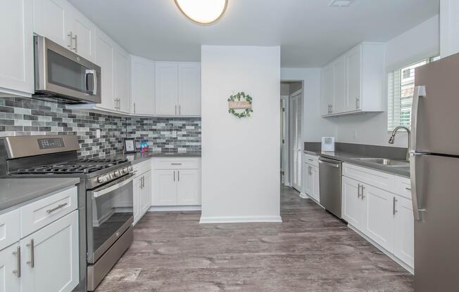 a kitchen with a stove sink and refrigerator