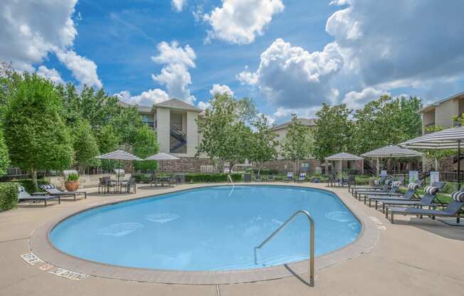Apartments In Houston Texas for Rent – Westchase Forest - Photo of a swimming pool with chairs and umbrellas