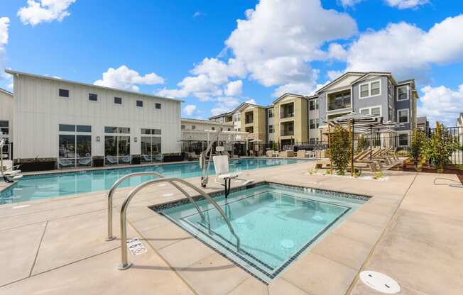 Spa entrance with stairs and railing, with ciew of Pool and clubhouse at Morgan Ranch Apartments, Morgan Hill, CA