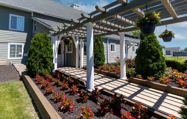 the front yard of a house with a porch and a pergola