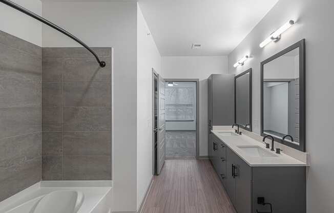 a bathroom with a shower and a sink and a mirror