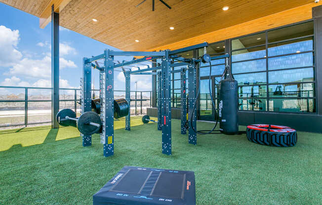 A gym with a green floor and a wooden ceiling.