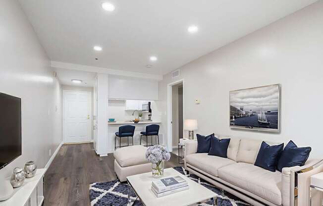 A modern living room with a white sofa and a coffee table.