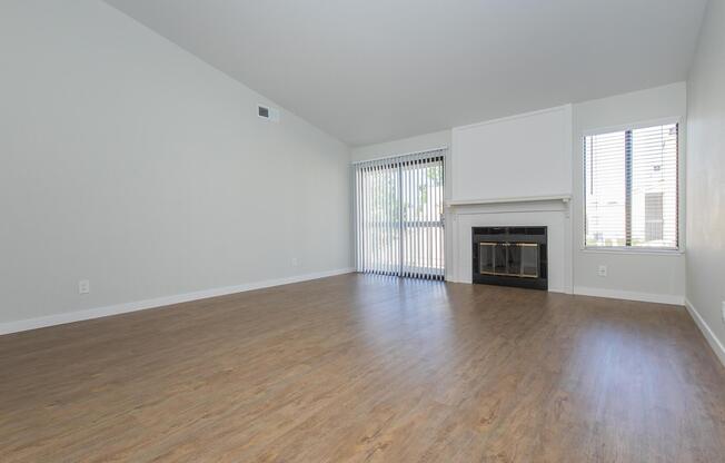 a large empty room with a wood floor