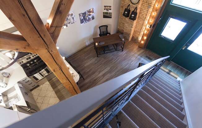 A staircase leads up to a living room with a couch and a coffee table.
