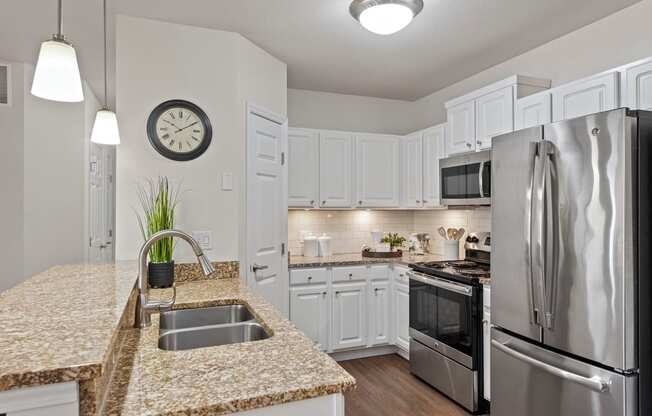 a kitchen with granite counter tops and stainless steel appliances