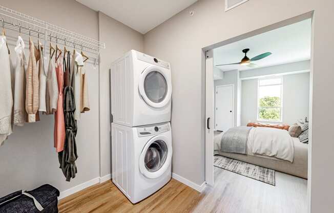 a washer and dryer in a closet in a bedroom