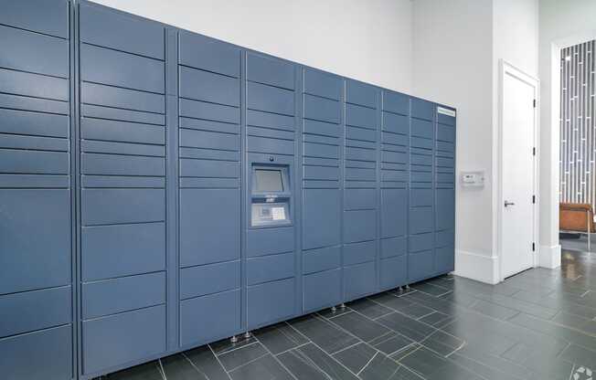 A row of blue lockers in a room.