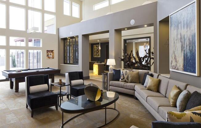 a living room filled with furniture and a pool table