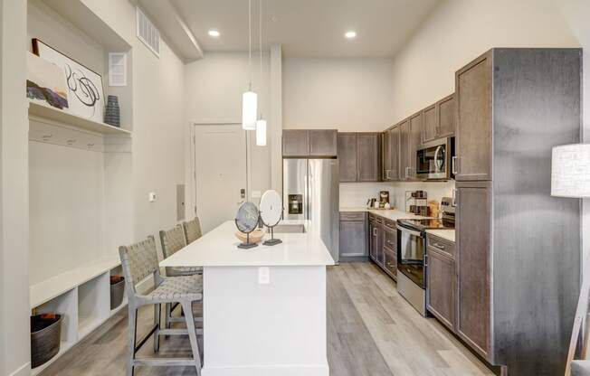 Kitchen with built-in mudroom space with hooks and shelving