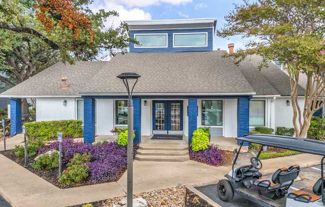 a blue house with a golf cart parked in front of it