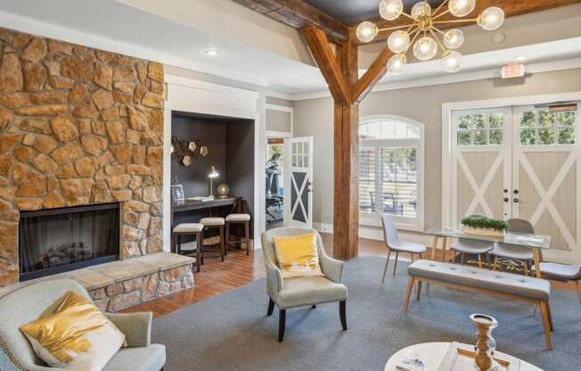 a living room with a fireplace and a table with chairs