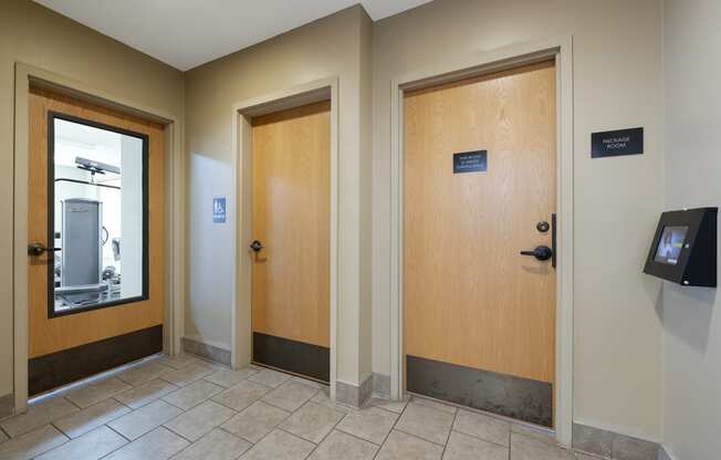 Apartments in Elk River MN_doors to the fitness center, bathroom and package room