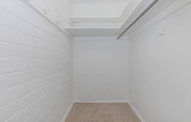 A white room with a carpeted floor and white walls.