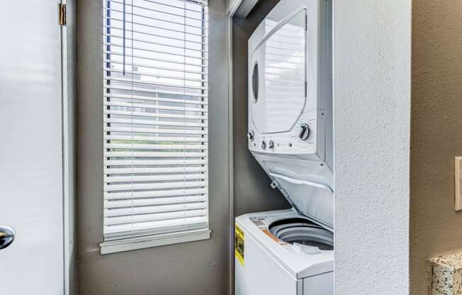 Laundry room has a washer and dryer and a window at Union Heights Apartments, Colorado Springs, CO