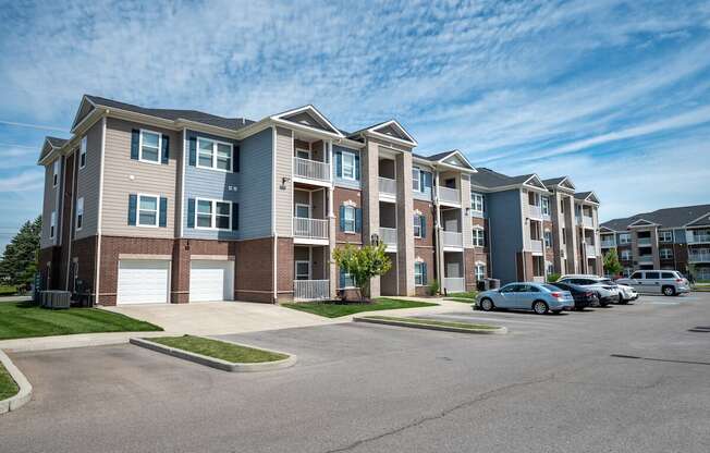 Row of apartment buildings with cars parked in front of them at Mosaic Apartments in Avon, Indiana