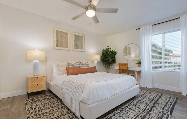 a bedroom with a bed and a ceiling fan