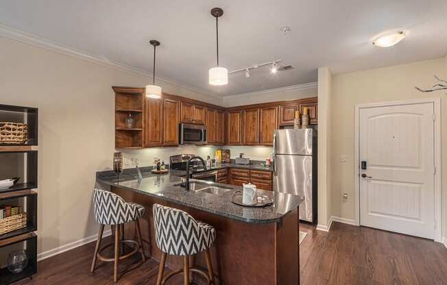 a kitchen with an island and three stools