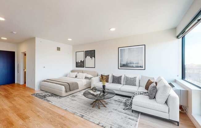 a living room with two couches and a glass coffee table