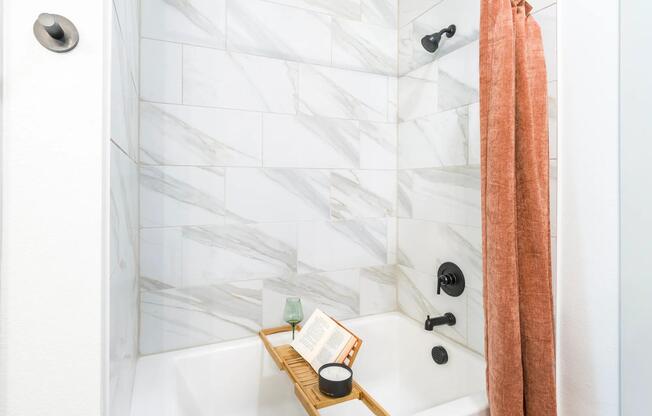 Designer bathrooms with quartz countertops and soaking tubs.