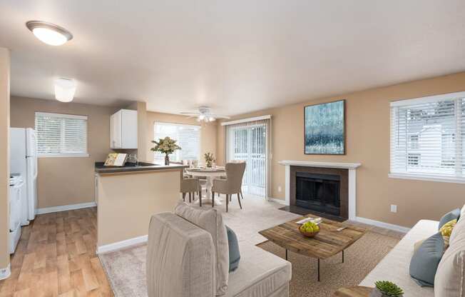 a living room with a fireplace and a dining room and kitchen