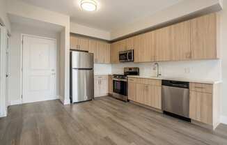 a kitchen with wooden cabinets and stainless steel appliances