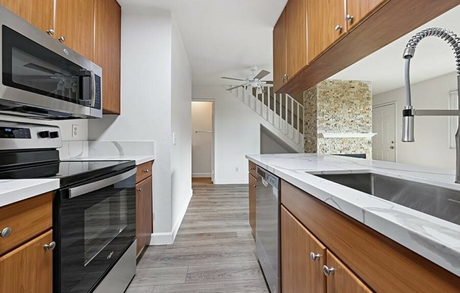 view of entry way from kitchen with vinyl wood like flooring and stainless steel appliances
