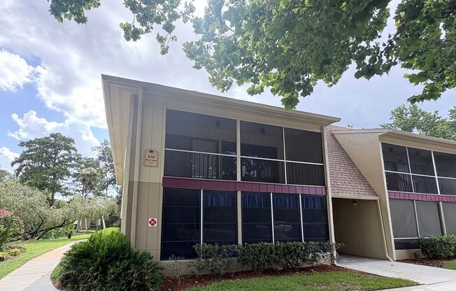 Nicely Updated 1/1 Condo in Winter Springs ~ Wood Plank Tile Floors and Large Screened Patio!