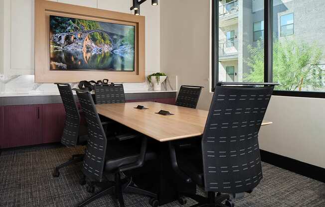 a conference room with a wooden table and chairs
