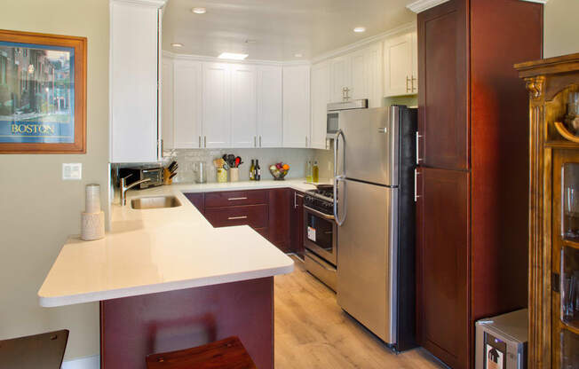 Apartment dining area and kitchen with appliances and built-in cabinets