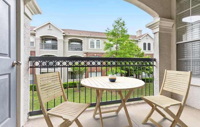 A patio with a table and two chairs is shown.