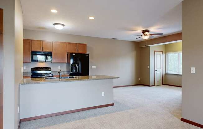 an adjacent living room and kitchen
