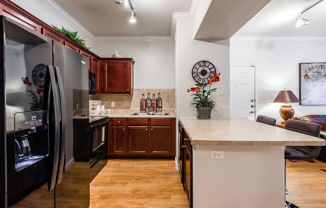 a modern kitchen with stainless steel appliances and wooden cabinets