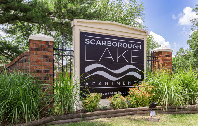 a sign for scarborough lake apartments in front of a gate