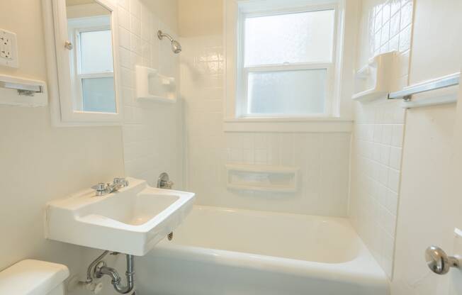 a small bathroom with a sink and a bath tub