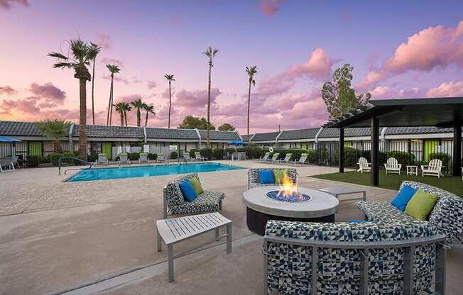 Outdoor Fire Pit Area and Swimming Pool with Lounge Furniture at Arcadia on 49th Apartments located in Phoenix, AZ.