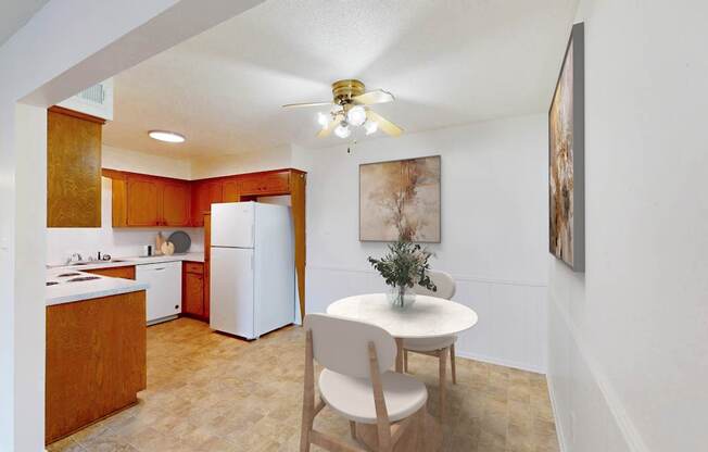 A kitchen with a table and chairs in the middle of the room.