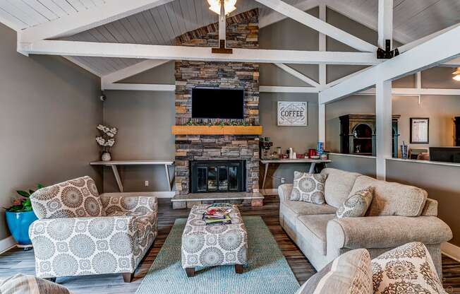 a living room with couches and chairs and a fireplace