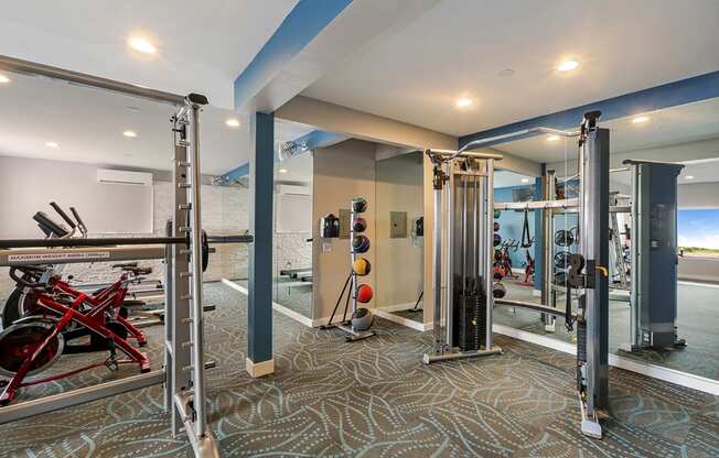 Fitness center with free weights and exercise equipment  at OceanAire Apartment Homes, California, 94044
