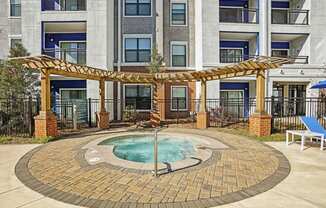 hot tub area and apartment building on sunny day