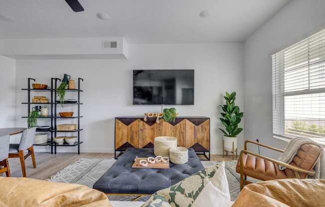 a living room with white walls and a tv on the wall