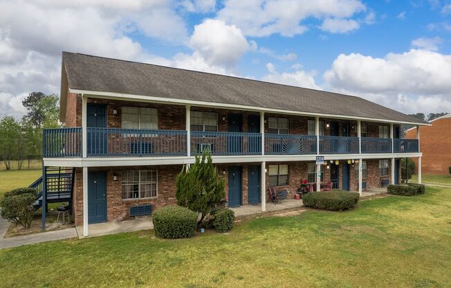 a house with a porch and a grass yard