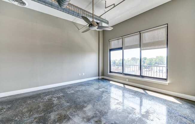 A room with a marble floor and a window overlooking a balcony.