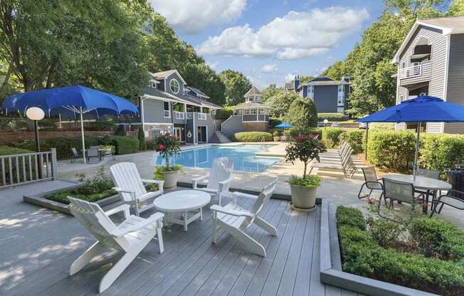 A backyard with a pool and deck.