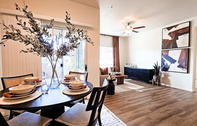 A dining room with a table set for a meal.