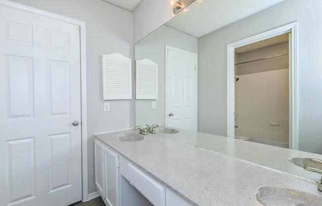 a kitchen with a sink and a mirror