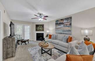 a living room with a couch and a ceiling fan