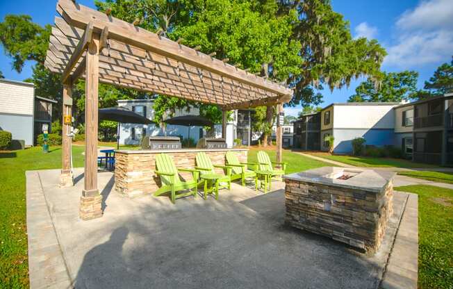 a patio with a fire pit and a pergola