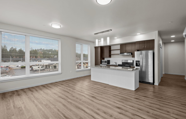 large open kitchen and living area with panoramic floor to ceiling windows and kitchen island