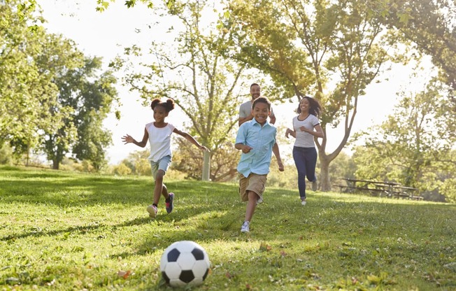 family-playing-soccer-in-park at Fairmont Apartments, Washington